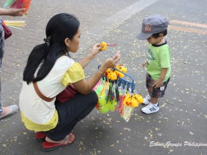 Child looking at the toys sold by a vendor in Quezon City