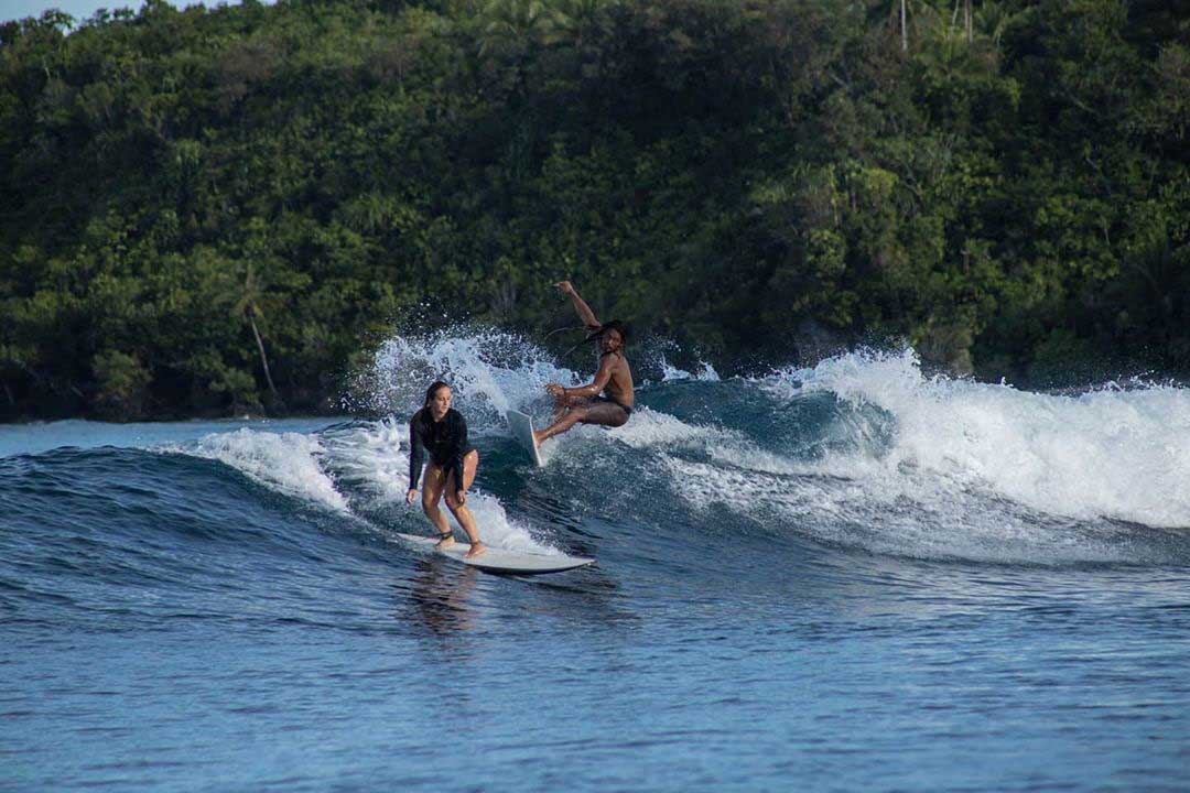 Surfers Riding the Waves in Siargao