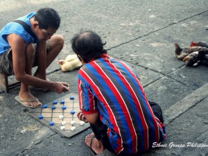 Men Playing Dama, a Traditional Board Game along Rizal Avenue in Iloilo City